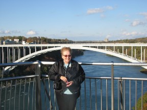 Betsy at Niagara Falls with the Rainbow Bridge in the background.