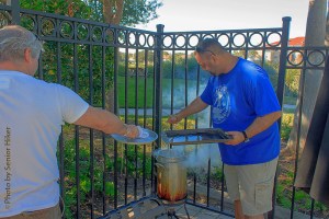 Robert and Darron putting turkey breasts into the fryer.  November 28, 2013.
