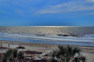 A fog bank casts sparkling light on the horizon.  Ocean Isle Beach, North Carolina.