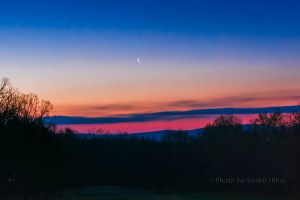 A crescent moon in the dawn sky behind our house. April 5, 2016.